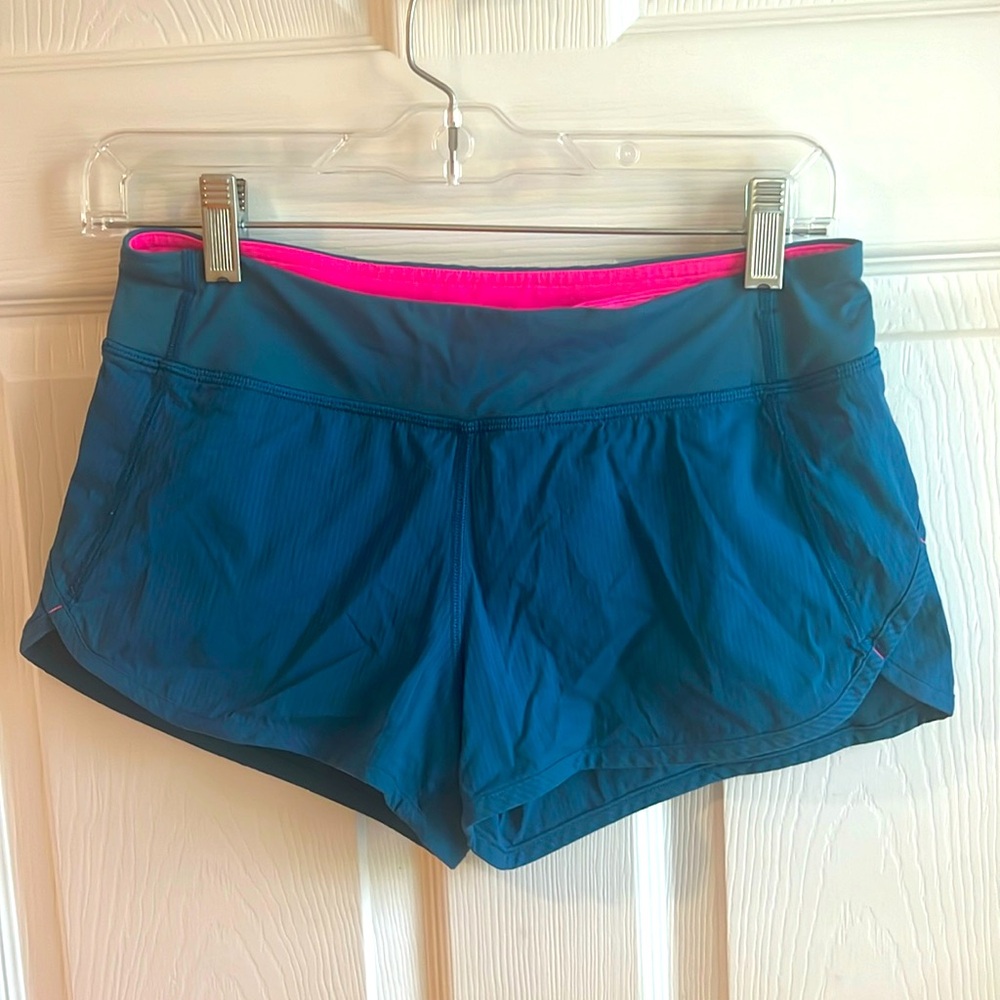 Ivivva shorts girls size 14. Fun teal color with hot pink details.